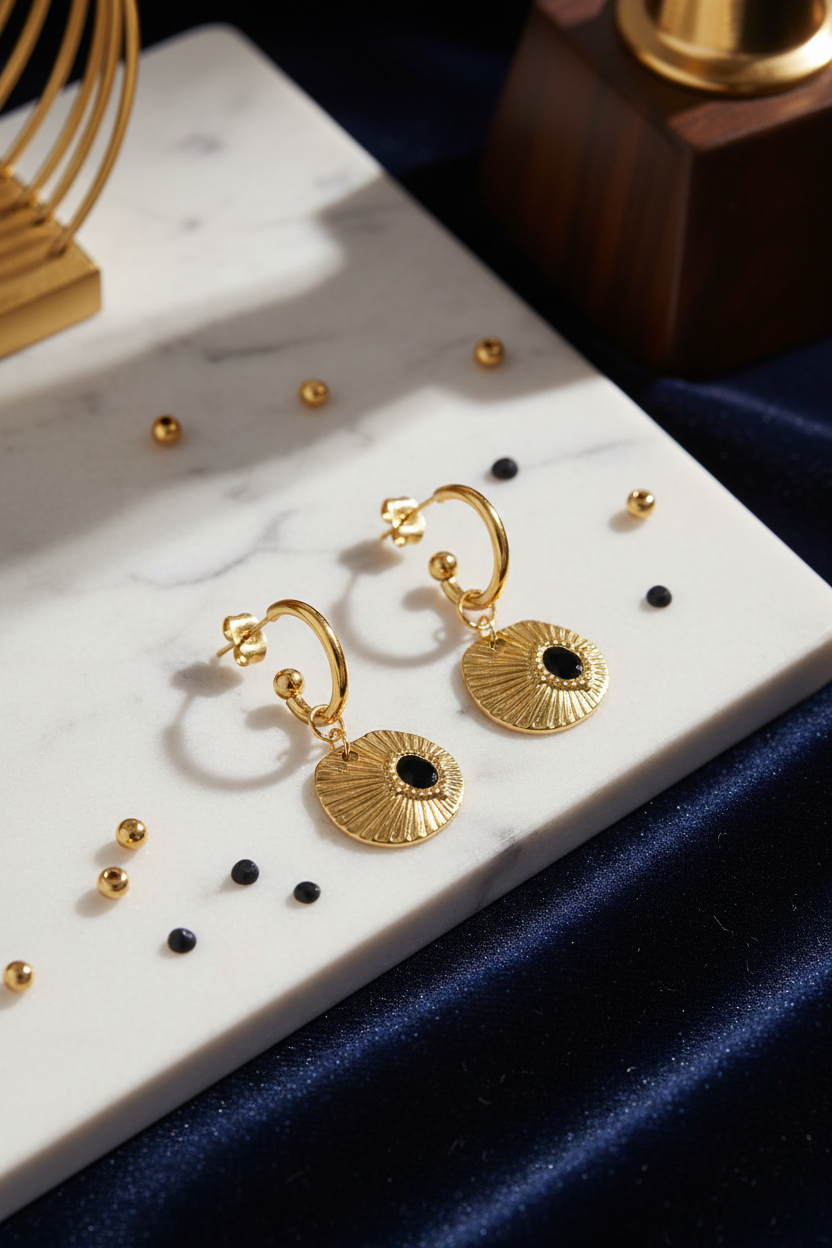 Gold earrings on sophisticated background