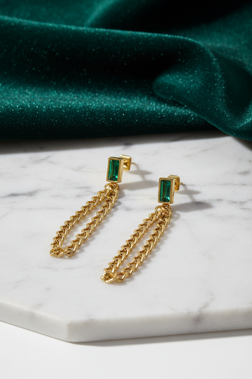 Gold chain earrings on sophisticated background