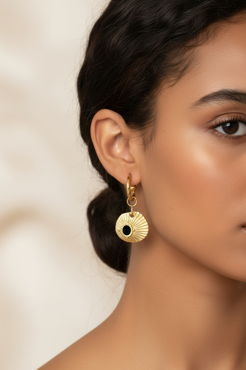 Gold earrings on brown-skinned model