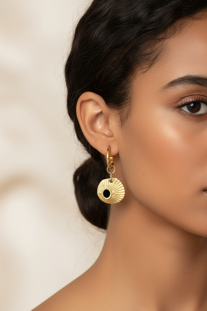 Gold earrings on brown-skinned model