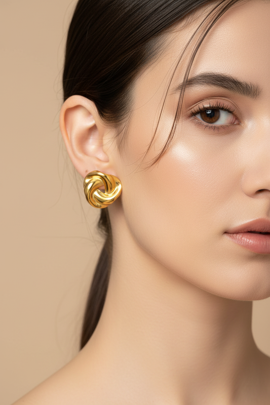 Gold knot earrings worn by model