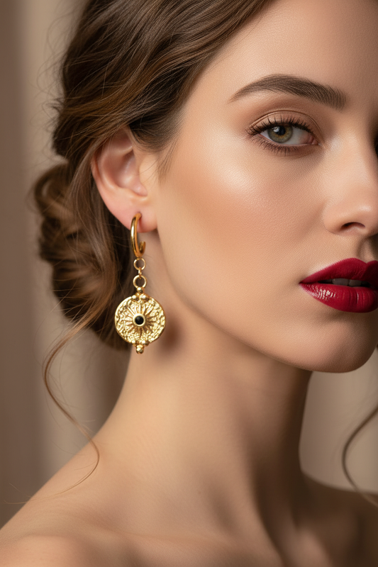 Model with bold red lips wearing gold earrings